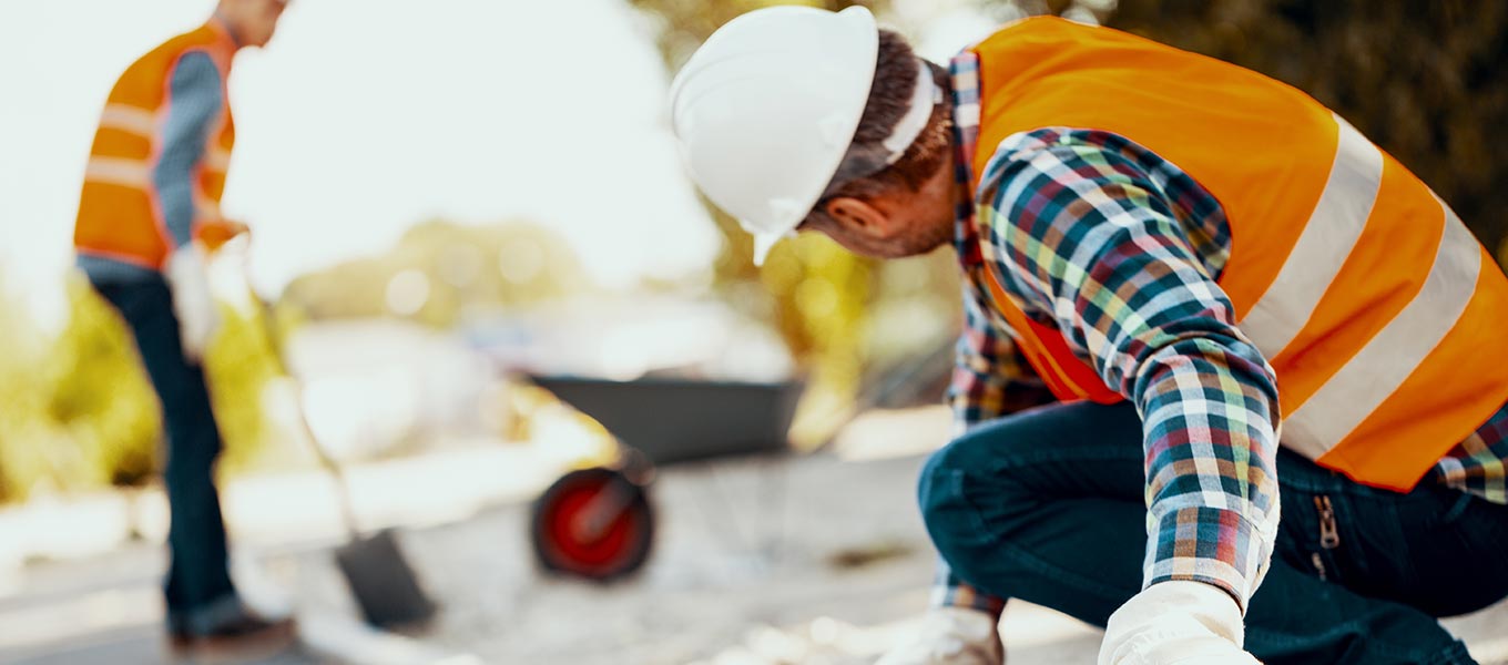 construction workers with wheel barrel