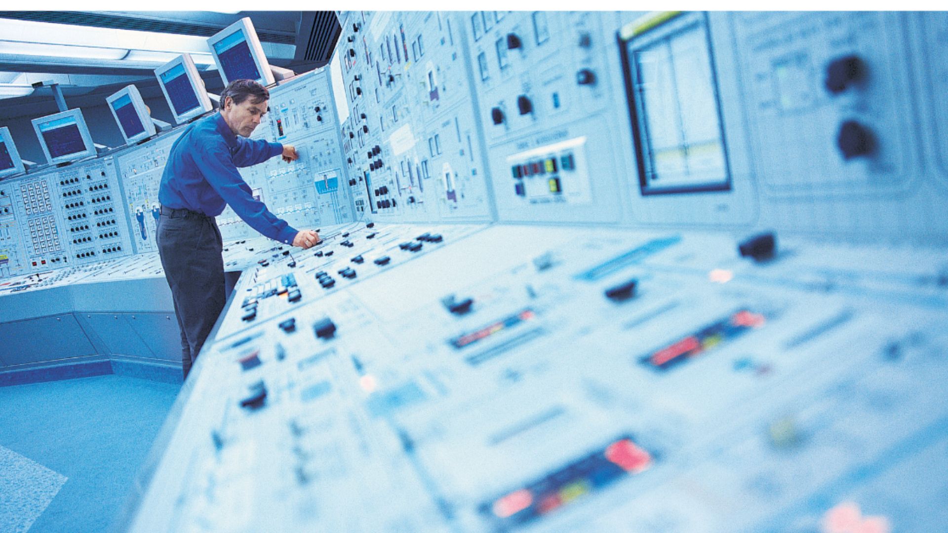 person working at extensive control panel